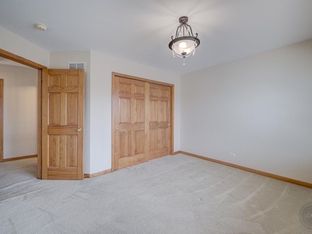 unfurnished bedroom with a closet and carpet