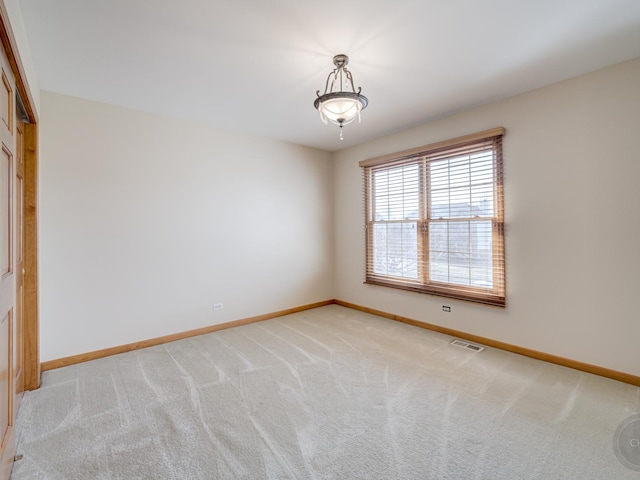 empty room with light colored carpet