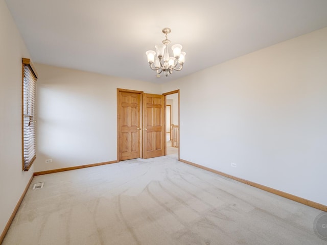 unfurnished bedroom featuring carpet, an inviting chandelier, and a closet