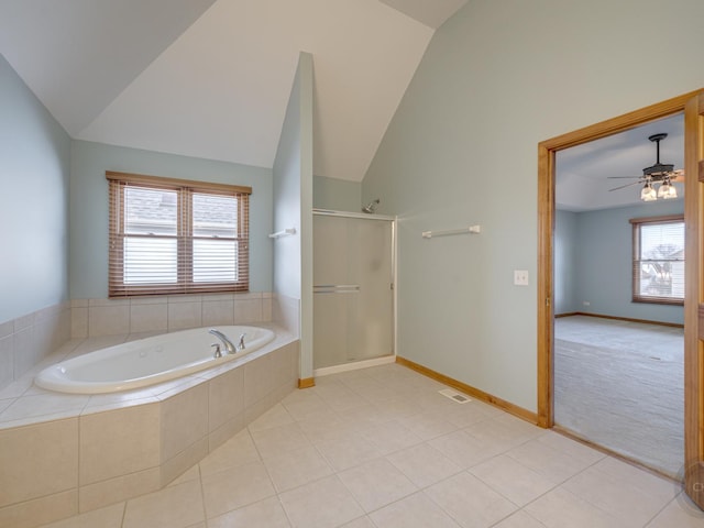 bathroom with tile patterned flooring, vaulted ceiling, shower with separate bathtub, and ceiling fan