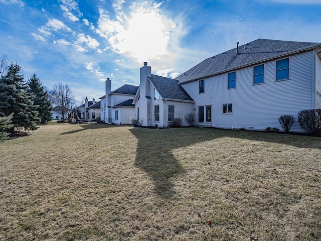 back of house featuring a yard