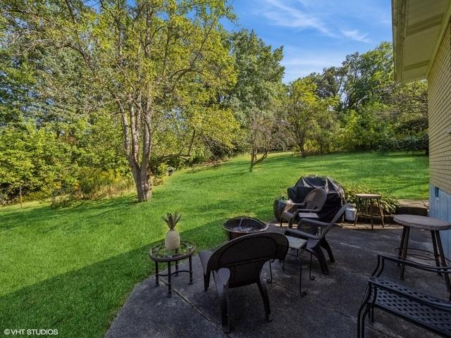 view of patio with grilling area and a fire pit