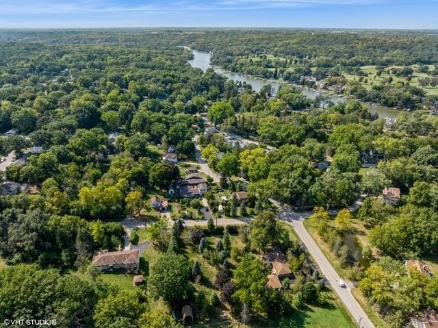 aerial view with a wooded view and a water view