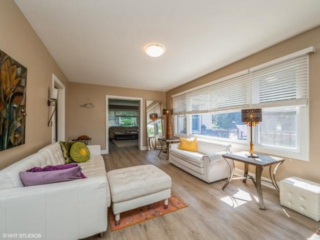 living room with baseboards and wood finished floors