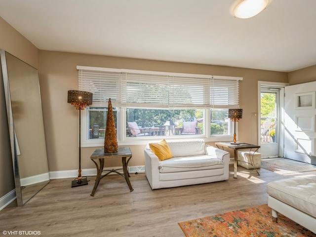 living area featuring baseboards and wood finished floors