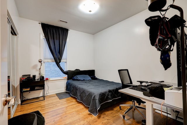 4820 W George St, Chicago, IL 60641 - bedroom with baseboards, visible vents, and wood finished floors