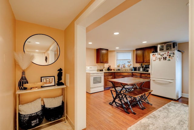 4820 W George St, Chicago, IL 60641 - kitchen featuring white appliances, light wood-type flooring, recessed lighting, and a sink