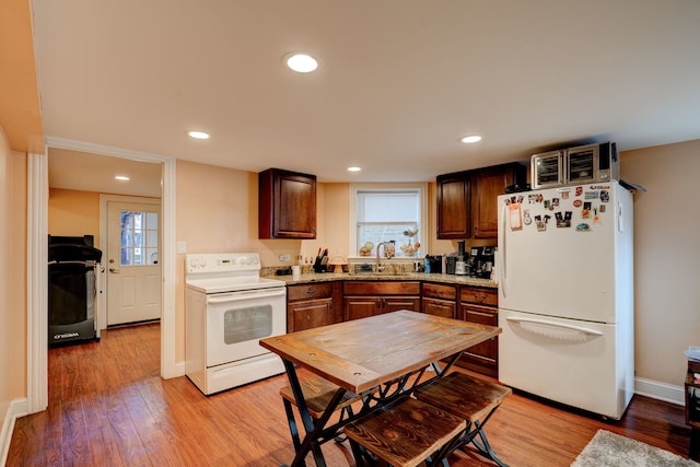 4820 W George St, Chicago, IL 60641 - kitchen with light wood-style flooring, a sink, recessed lighting, and white appliances