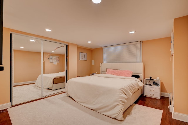 4820 W George St, Chicago, IL 60641 - bedroom featuring baseboards, dark wood-style flooring, recessed lighting, and baseboard heating