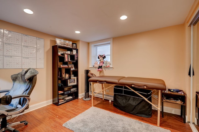 4820 W George St, Chicago, IL 60641 - office with baseboards, wood finished floors, recessed lighting, and a baseboard radiator
