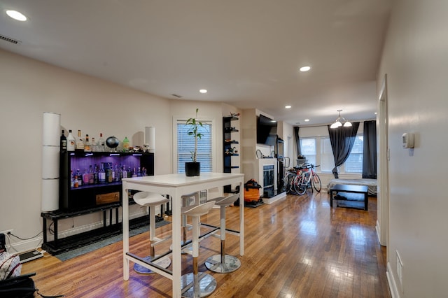 4820 W George St, Chicago, IL 60641 - dining room featuring visible vents, a bar, a fireplace, recessed lighting, and wood-type flooring