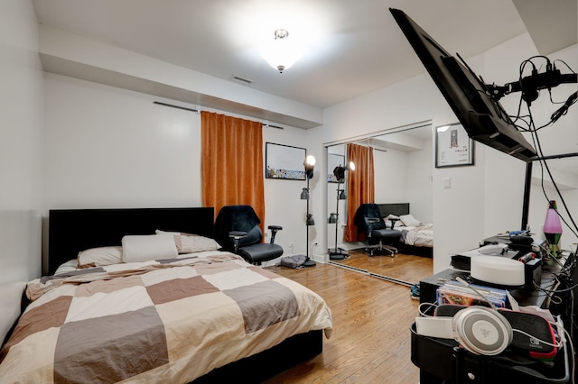 4820 W George St, Chicago, IL 60641 - bedroom featuring visible vents, a closet, and wood finished floors