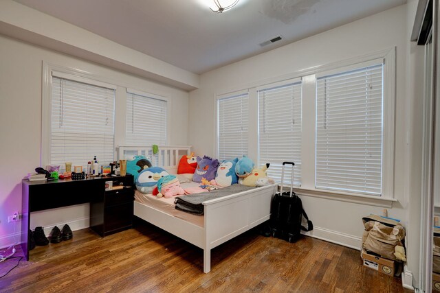4820 W George St, Chicago, IL 60641 - bedroom with baseboards, visible vents, and wood finished floors