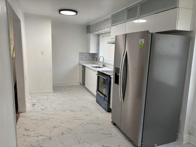 kitchen with sink, stainless steel appliances, and white cabinets