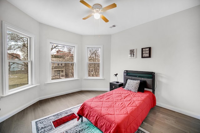 bedroom with wood-type flooring and ceiling fan