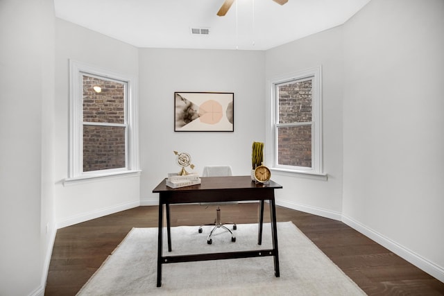 office with dark wood-type flooring and ceiling fan