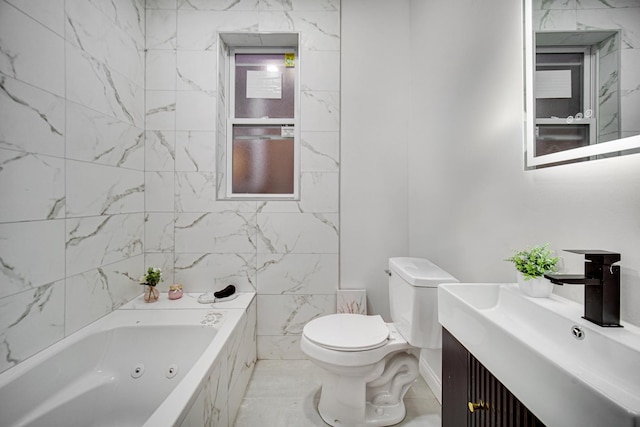 bathroom featuring vanity, a bath, and toilet