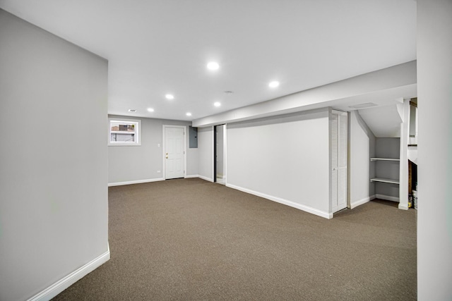 basement featuring dark colored carpet