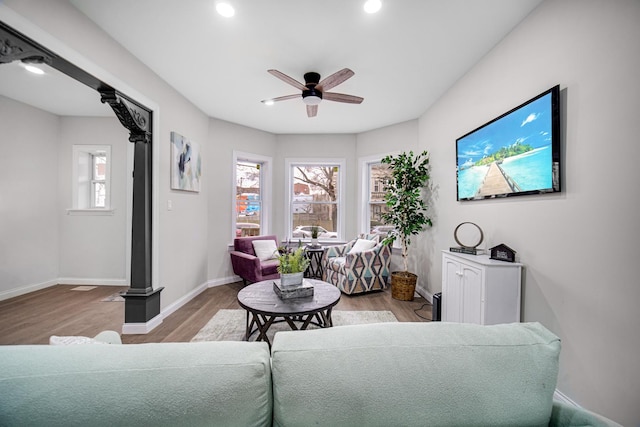 living room featuring ceiling fan, plenty of natural light, and light wood-type flooring