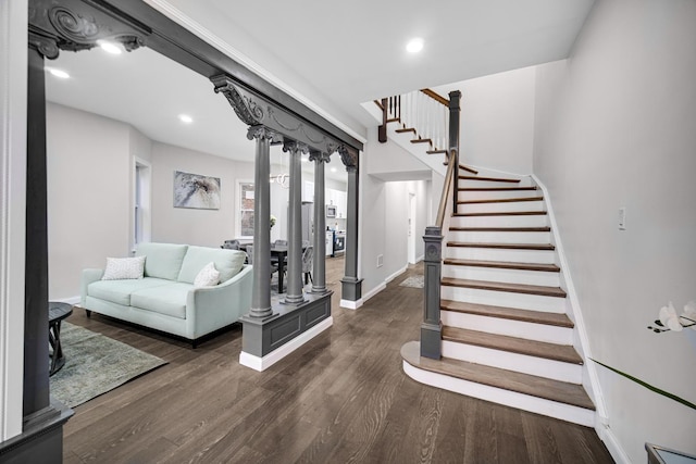 interior space featuring dark wood-type flooring and ornate columns