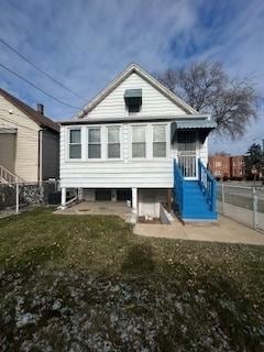 back of house with a lawn