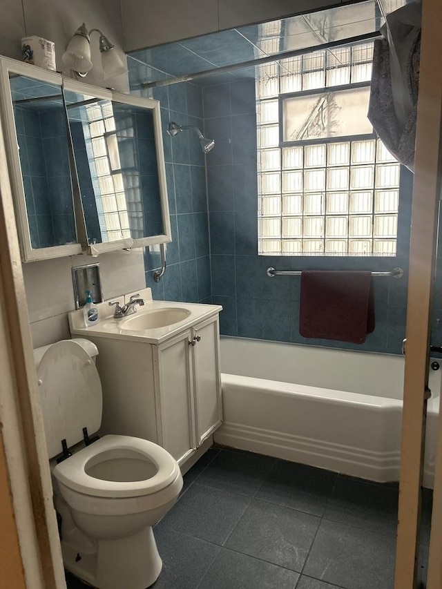 full bathroom with tiled shower / bath, vanity, toilet, and tile patterned flooring