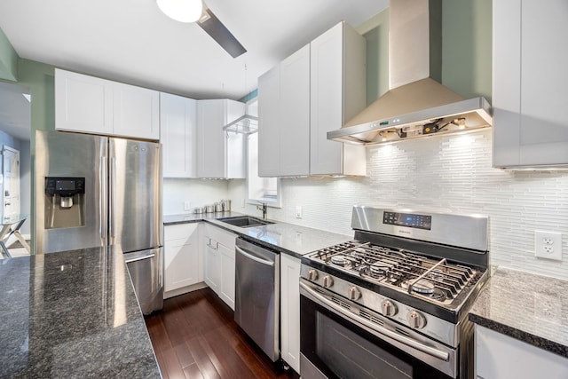 kitchen with white cabinetry, extractor fan, appliances with stainless steel finishes, and sink