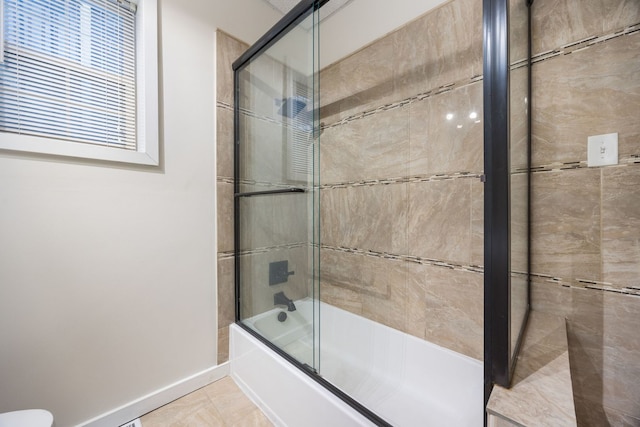 bathroom featuring shower / bath combination with glass door and toilet