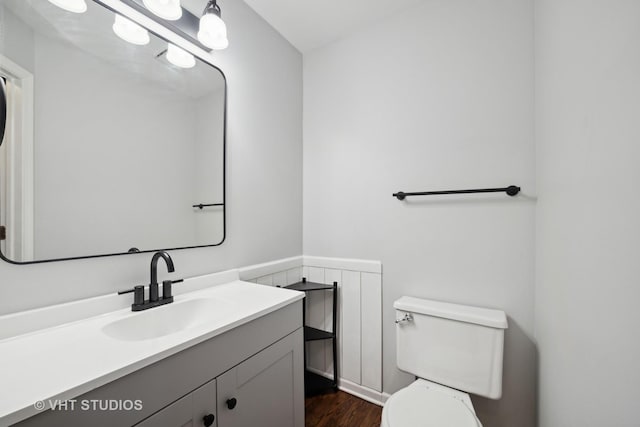 bathroom with vanity, wood-type flooring, and toilet