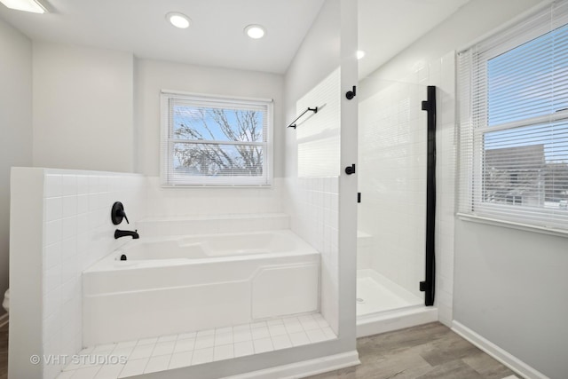 bathroom featuring hardwood / wood-style flooring and shower with separate bathtub