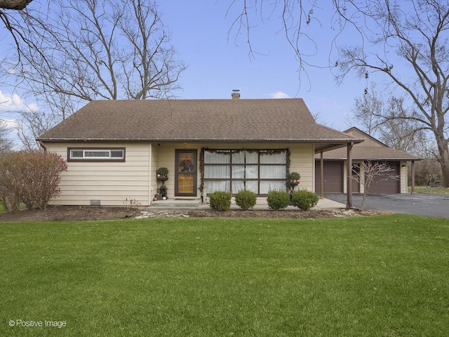 view of front of house featuring a garage and a front lawn