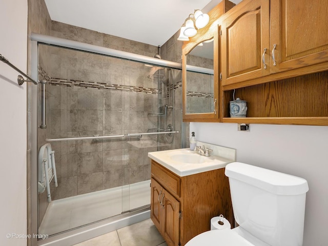 bathroom with vanity, an enclosed shower, tile patterned floors, and toilet