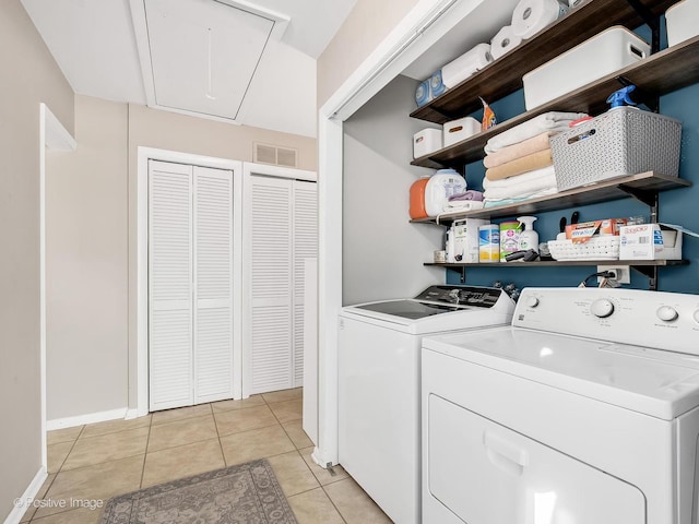 laundry room featuring light tile patterned floors and washing machine and clothes dryer