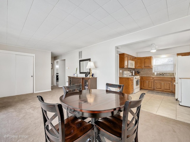 carpeted dining space featuring sink