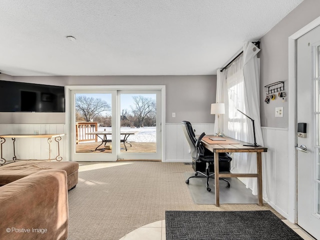 carpeted office space with a textured ceiling