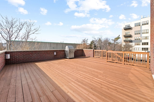 wooden deck with a grill