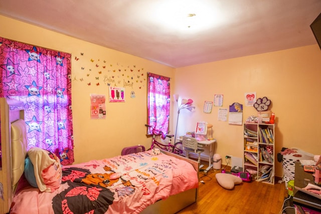 bedroom with hardwood / wood-style flooring