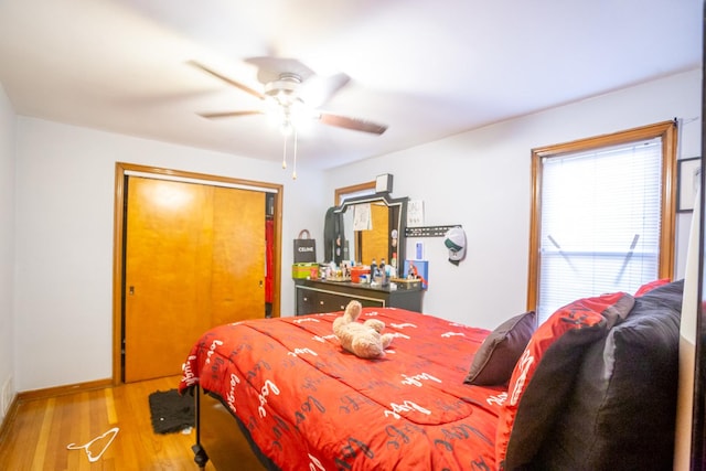 bedroom with wood-type flooring and ceiling fan