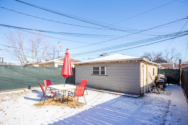 view of snow covered back of property