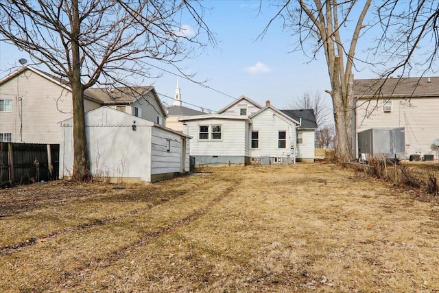 back of property featuring a lawn