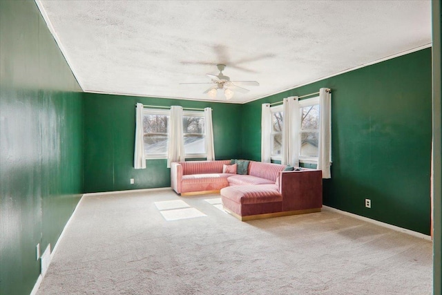 sitting room with ornamental molding, light carpet, a textured ceiling, and ceiling fan