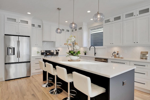 kitchen featuring stainless steel appliances, a kitchen island, and white cabinets