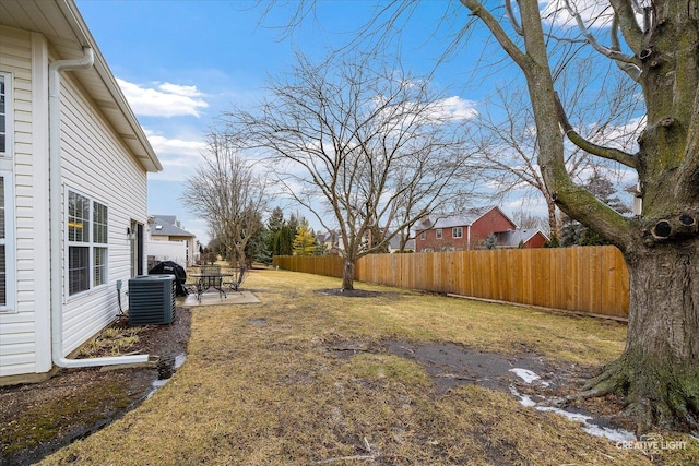 view of yard with central AC unit and a patio area