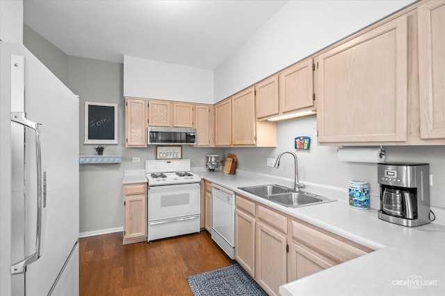 kitchen featuring light brown cabinetry, sink, white appliances, and dark wood-type flooring