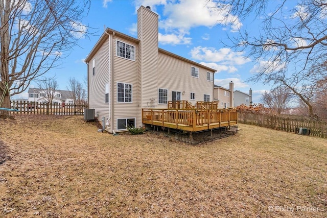 back of house featuring cooling unit, a yard, and a deck