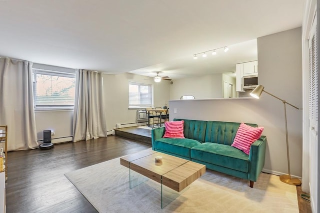 living room with wood-type flooring, ceiling fan, and a baseboard radiator