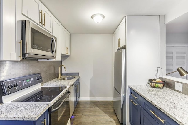 kitchen featuring stainless steel appliances, sink, blue cabinets, and white cabinets