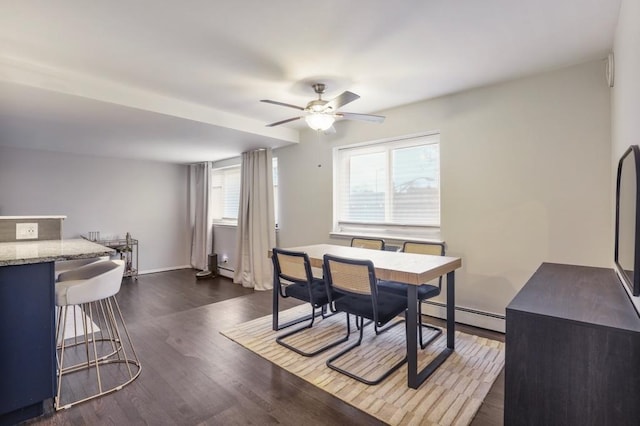 dining area featuring a baseboard radiator, dark hardwood / wood-style floors, and ceiling fan