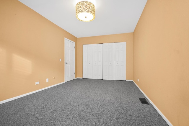 unfurnished bedroom featuring carpet and a closet