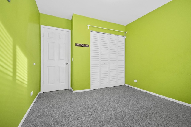 unfurnished bedroom featuring carpet and a closet